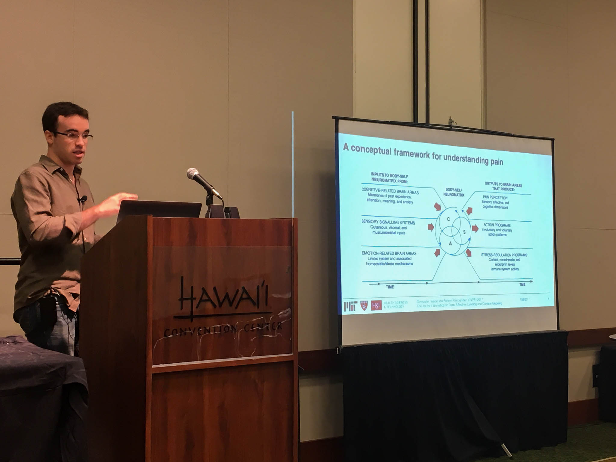 Daniel Lopez-Martinez presenting at the podium at the CVPR 2017 Workshop on Deep Affective Learning and Context Modeling in Honolulu, Hawaii.